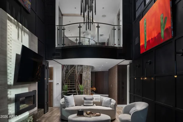 a living room with furniture a flat screen tv and a fireplace