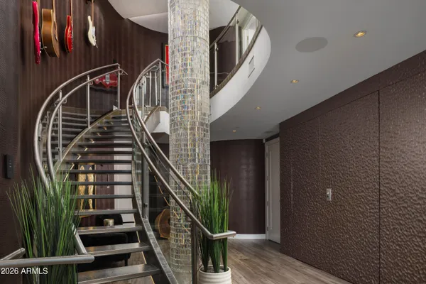 a view of staircase with wooden floor and white walls