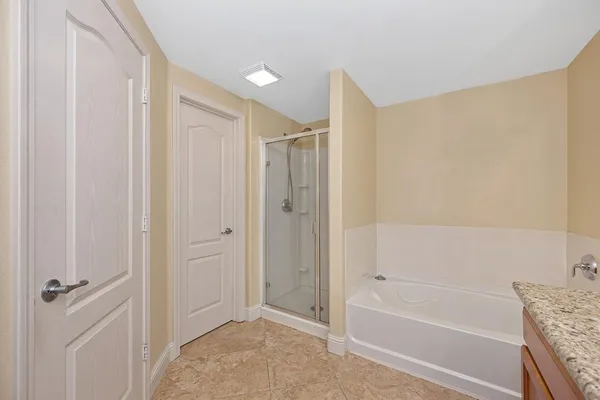 a bathroom with a shower and a bath tub