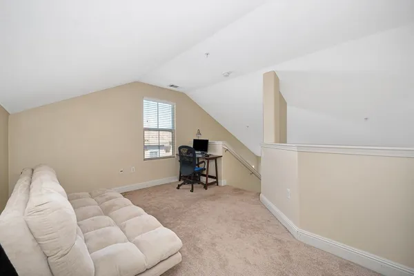 a living room with furniture and white walls