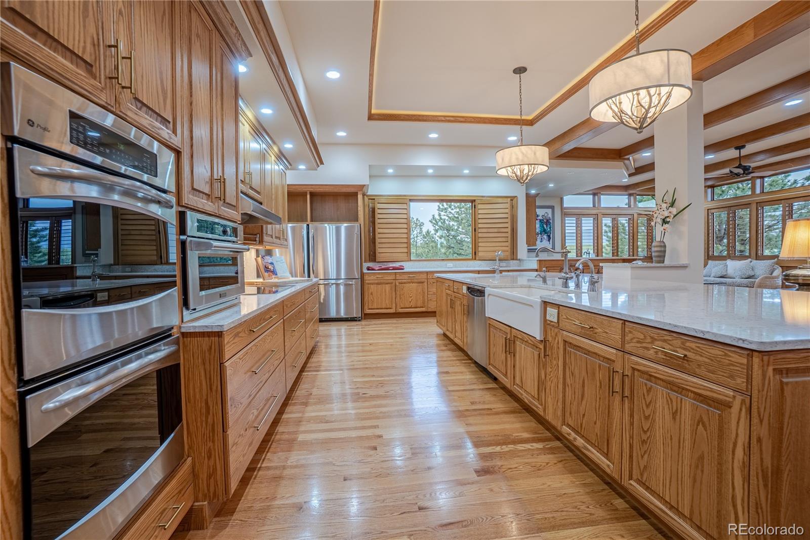 3282 Tomah Road Larkspur, CO 80118 - Photo 19 of 35 a large kitchen with stainless steel appliances and large windows