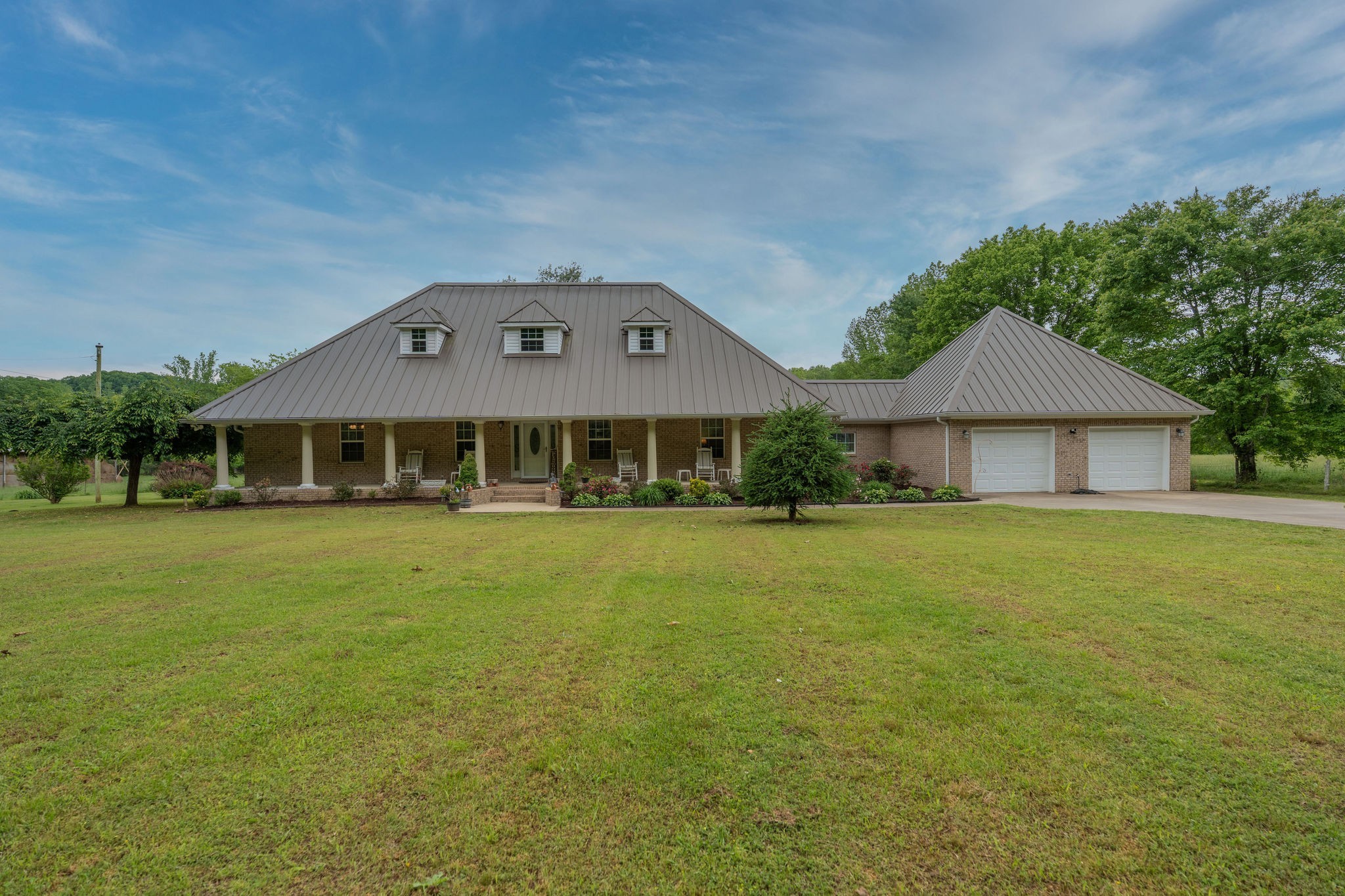a front view of a house with a garden