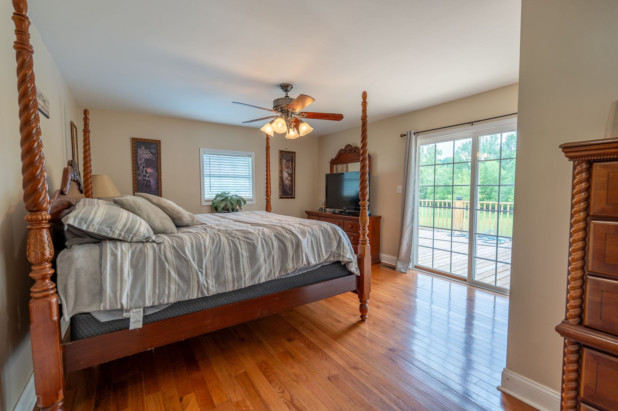 8276 Middle Butler Road Iron City, TN 38463 - Photo 17 of 27 a bedroom with a large bed a flat tv screen and dresser