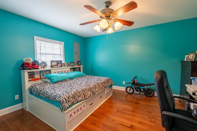a bedroom with a bed and a chandelier