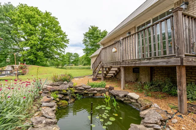 a view of a house with backyard and sitting area