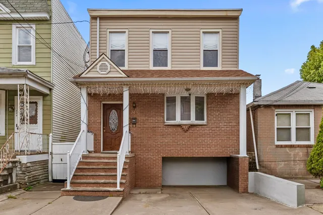 a front view of a house with a large window