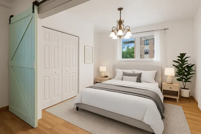 a spacious bedroom with a bed and a chandelier