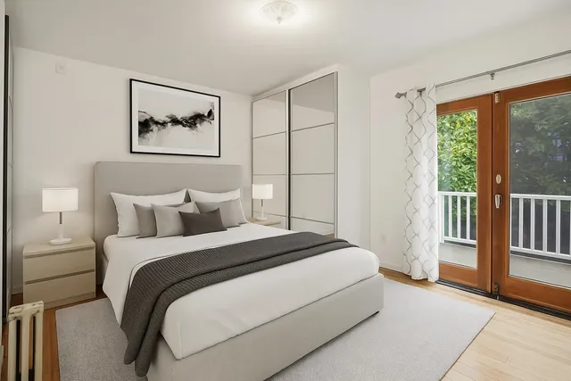 a bedroom with a large bed and a large window