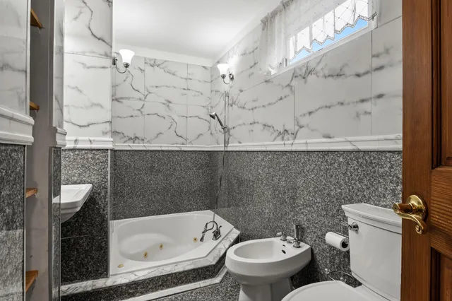 a bathroom with a toilet and a bathtub