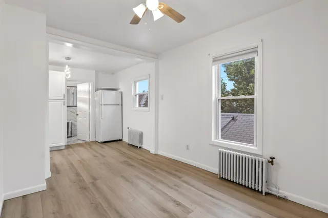 an empty room with windows and closet