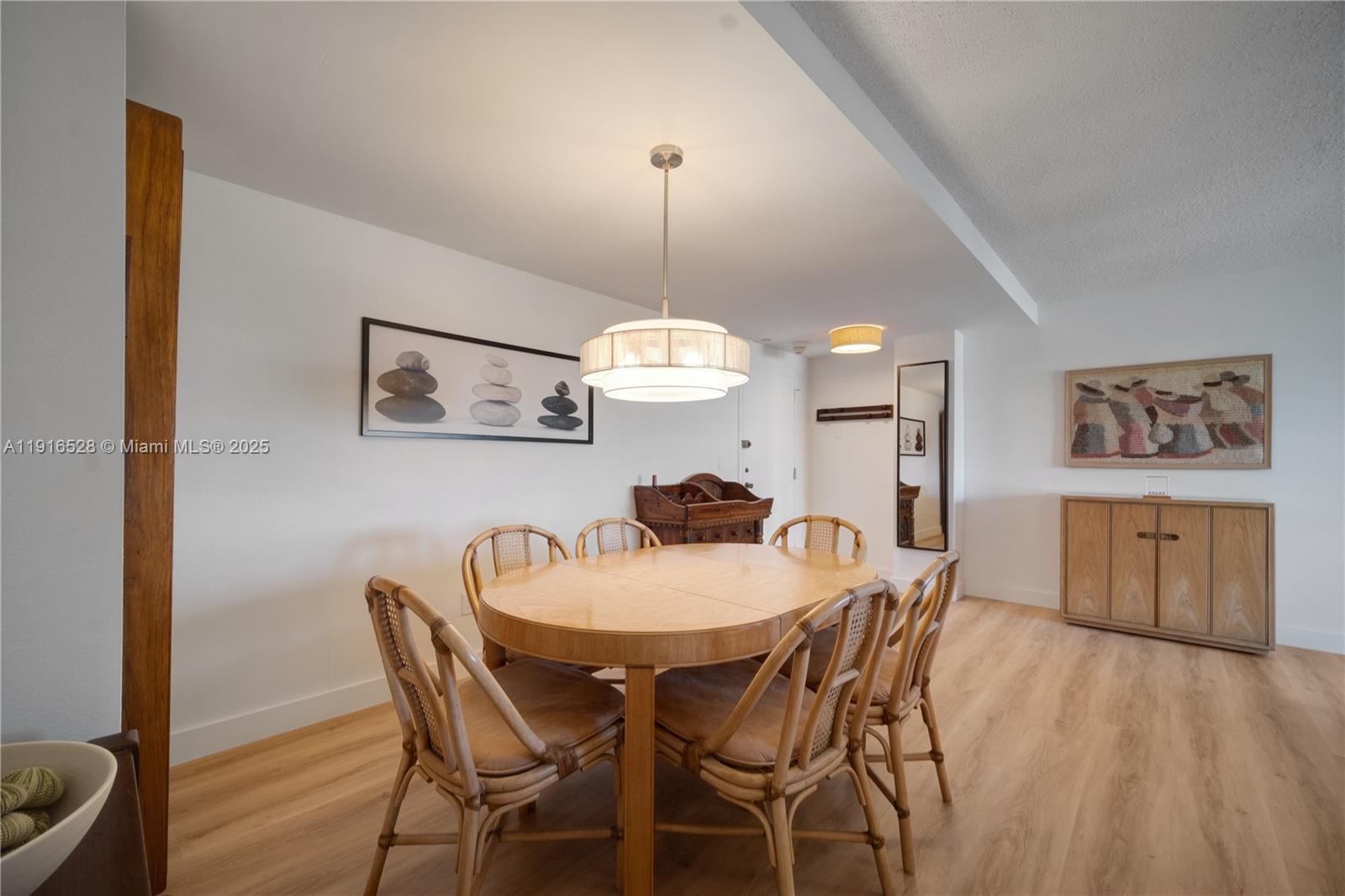 77 Crandon Boulevard, Unit 10C Key Biscayne, FL 33149 - Photo 13 of 37 a dining room with furniture and wooden floor