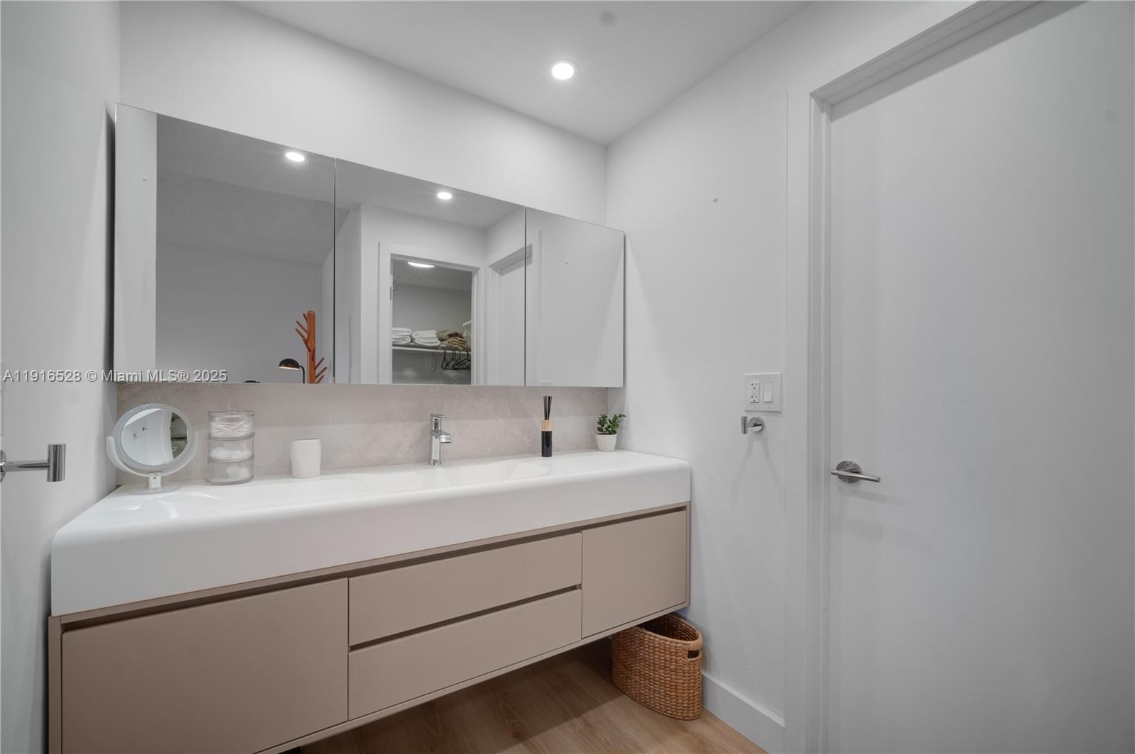 77 Crandon Boulevard, Unit 10C Key Biscayne, FL 33149 - Photo 19 of 37 a bathroom with a sink and a mirror