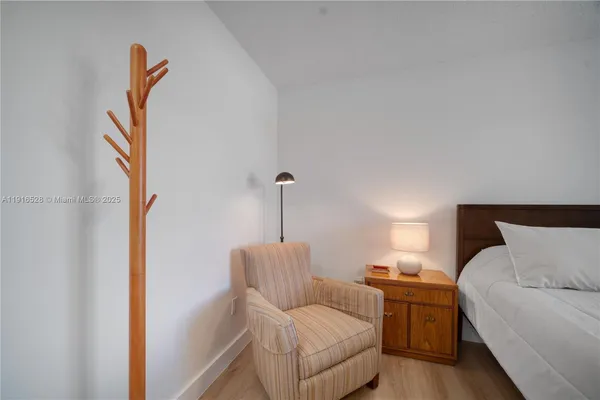 a living room with furniture and a painting on the wall