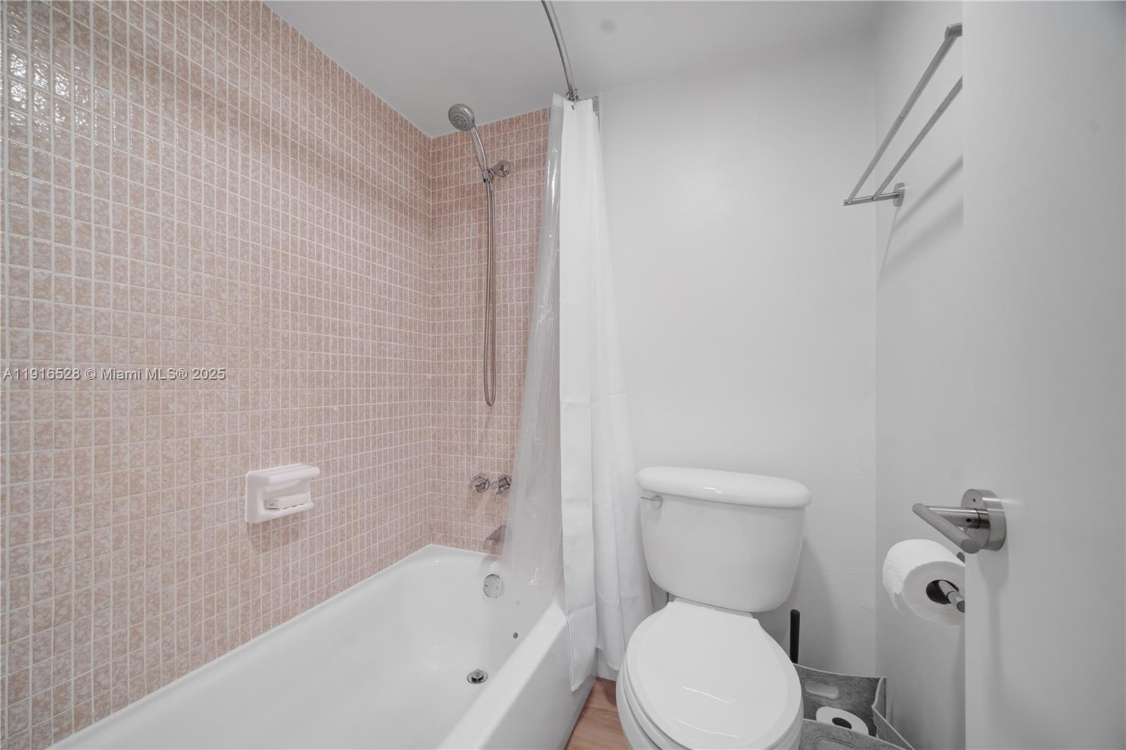 77 Crandon Boulevard, Unit 10C Key Biscayne, FL 33149 - Photo 23 of 37 a white toilet sitting next to a bath tub