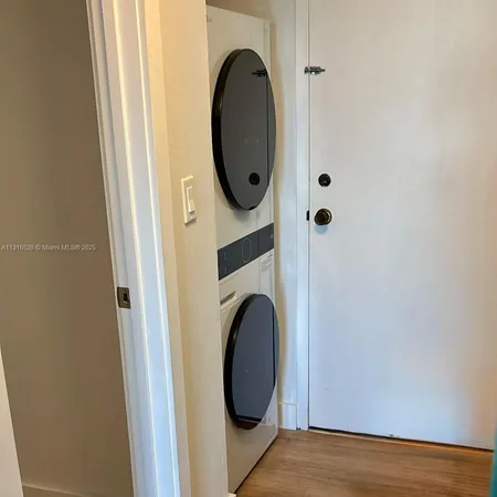 a view of a door in a utility room with washer and dryer