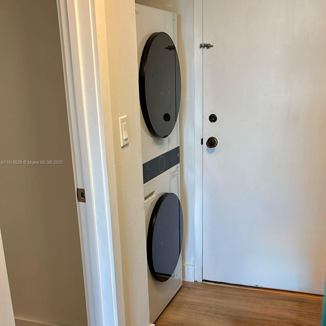 77 Crandon Boulevard, Unit 10C Key Biscayne, FL 33149 - Photo 27 of 37 a view of a door in a utility room with washer and dryer