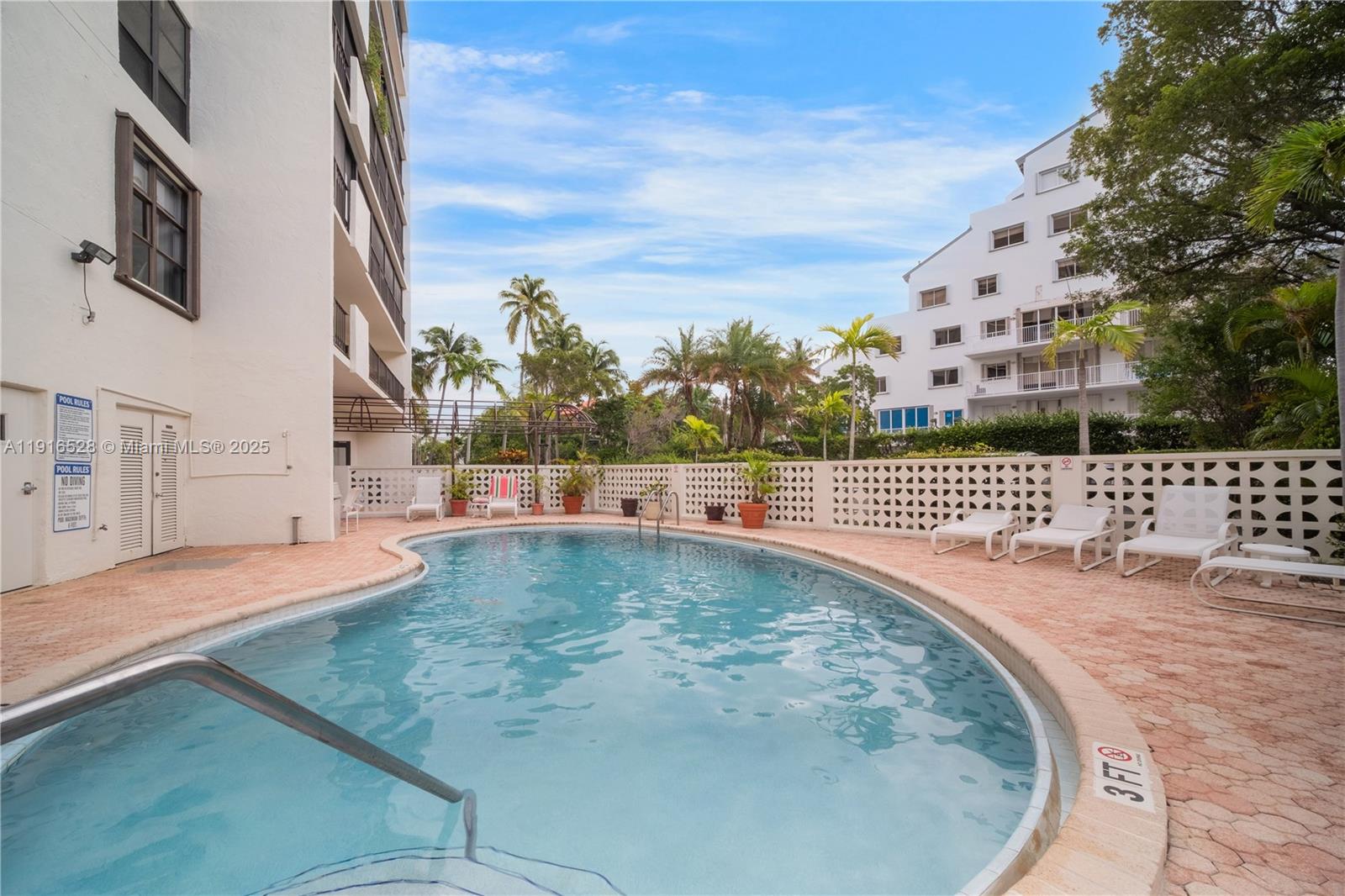 77 Crandon Boulevard, Unit 10C Key Biscayne, FL 33149 - Photo 30 of 37 a view of a swimming pool with an outdoor space