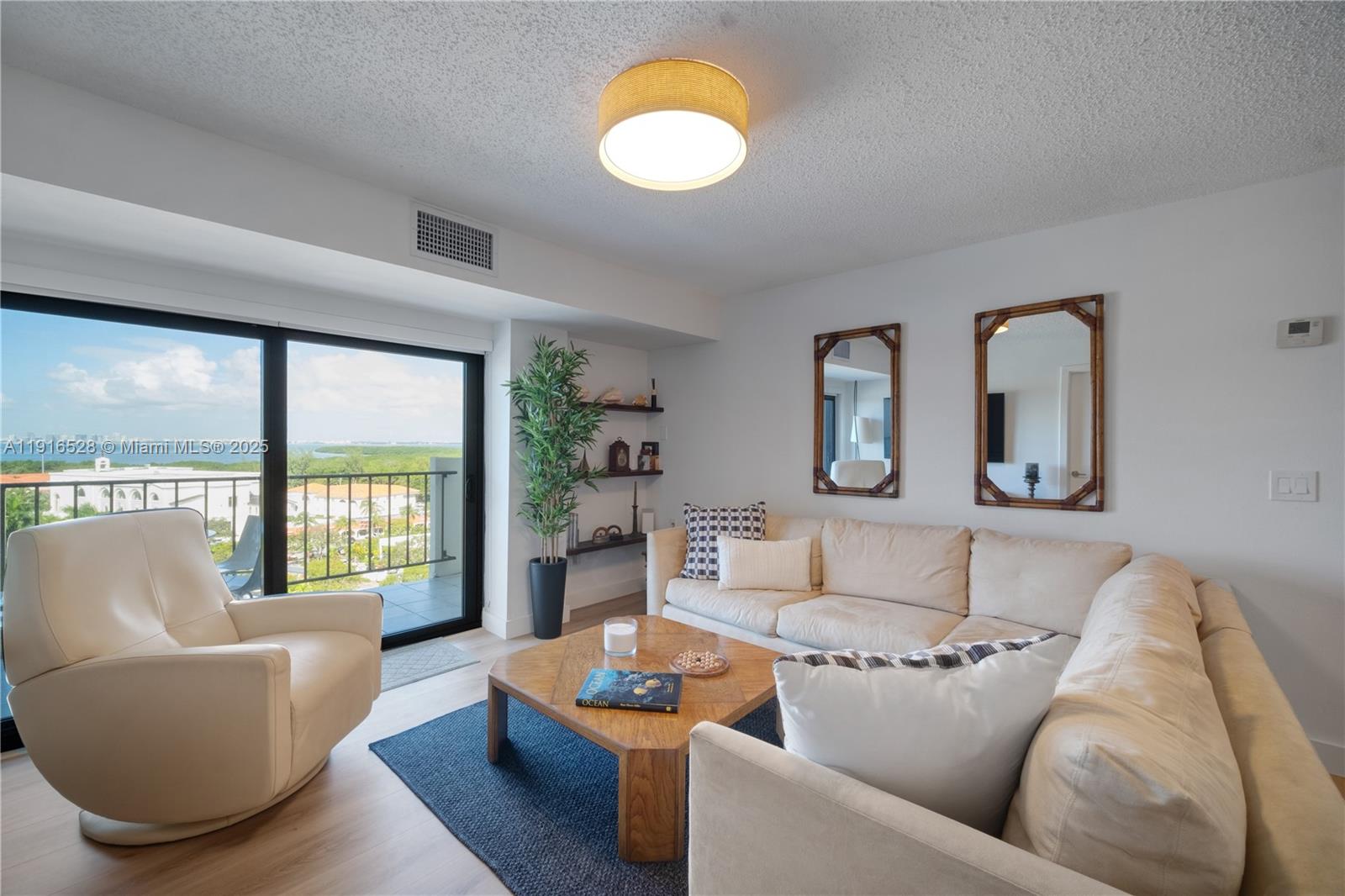 77 Crandon Boulevard, Unit 10C Key Biscayne, FL 33149 - Photo 6 of 37 a living room with furniture and a large window