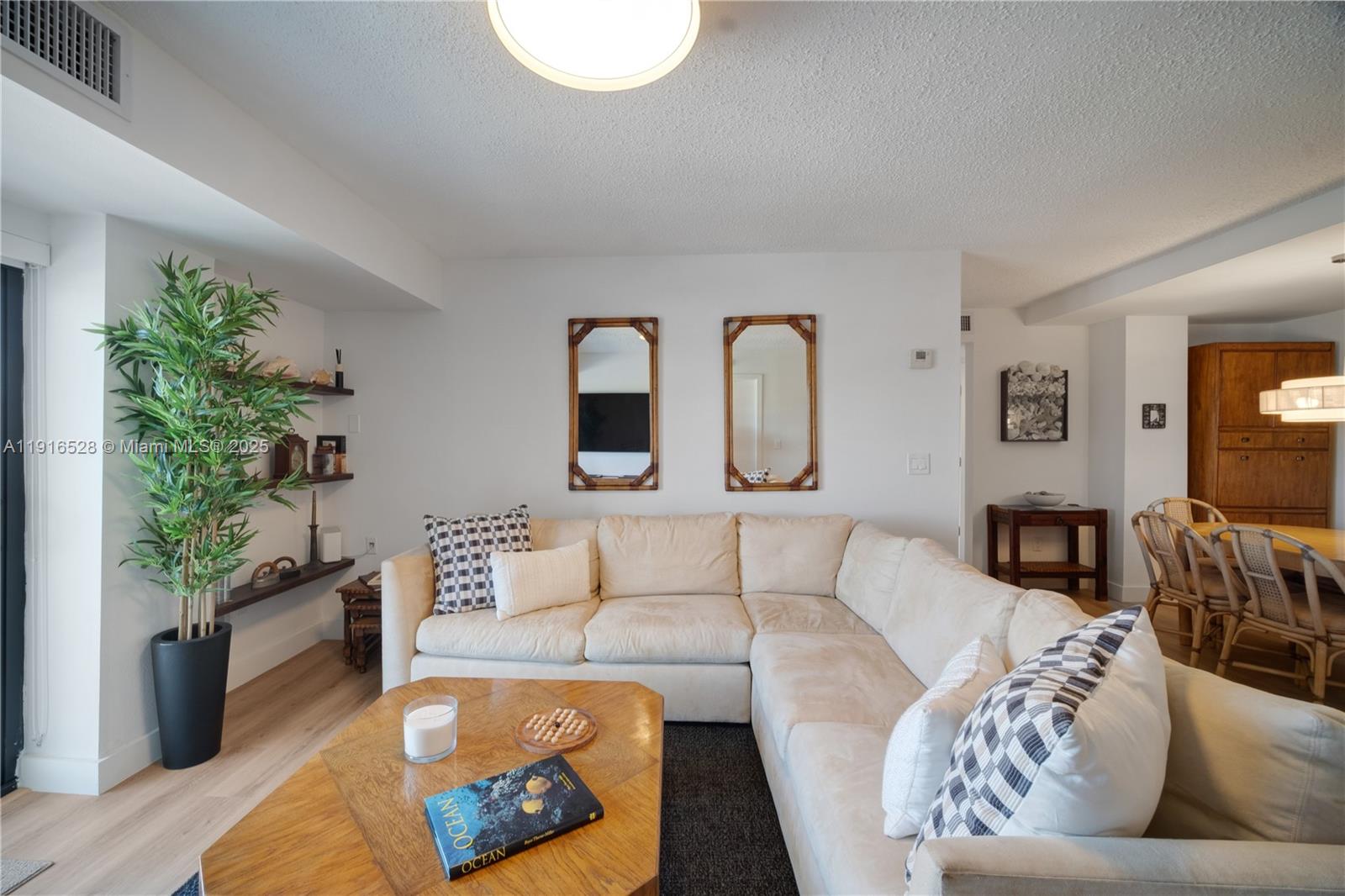77 Crandon Boulevard, Unit 10C Key Biscayne, FL 33149 - Photo 7 of 37 a living room with furniture and a potted plant