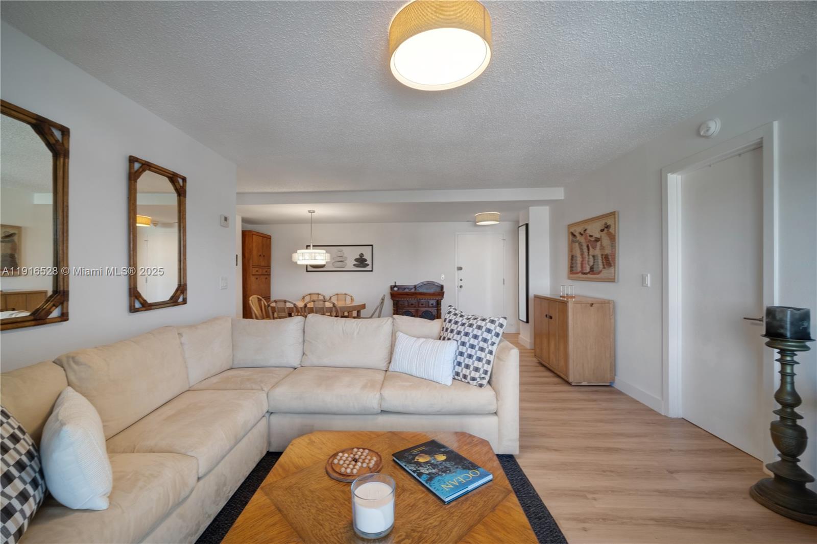 77 Crandon Boulevard, Unit 10C Key Biscayne, FL 33149 - Photo 8 of 37 a living room with furniture and a window