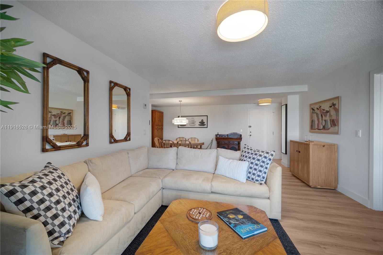 77 Crandon Boulevard, Unit 10C Key Biscayne, FL 33149 - Photo 9 of 37 a living room with furniture and a window
