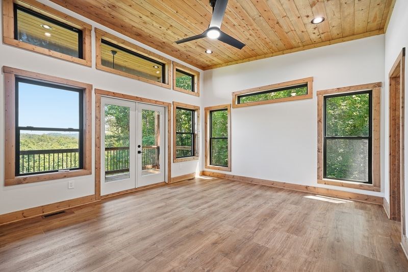 216 Old Orchard Road Ellijay, GA 30536 - Photo 3 of 59 a view of an empty room with wooden floor and a window