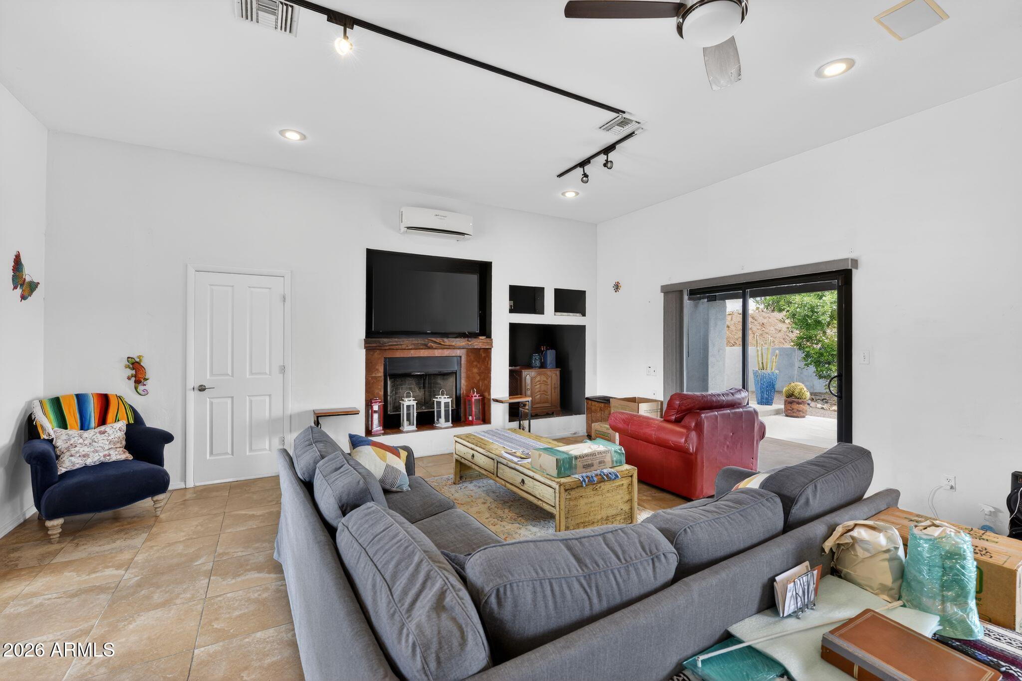 277 Círculo Silva Rio Rico, AZ 85648 - Photo 11 of 34 a living room with furniture and a flat screen tv