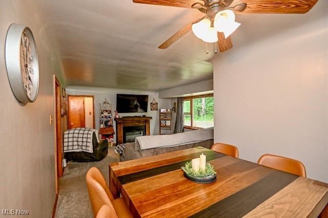 3364 Cormany Road Akron, OH 44319 - Photo 30 of 44 Carpeted dining space with a fireplace and ceiling fan