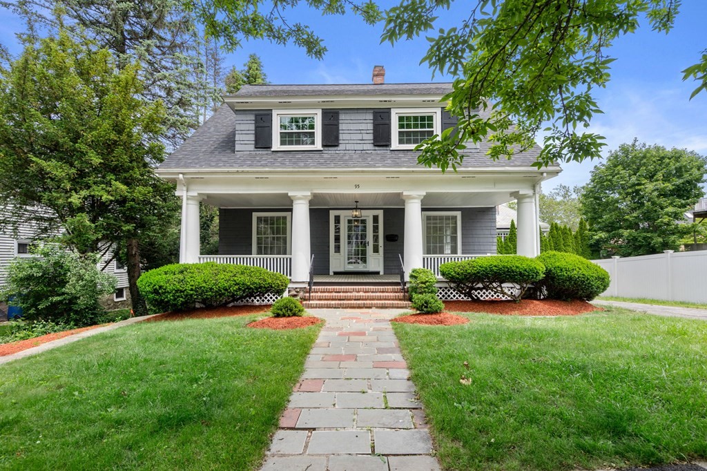 a front view of a house with garden and porch