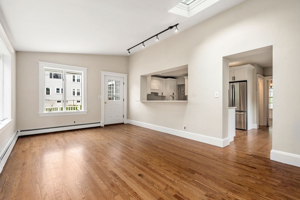 95 Russett Road Boston, MA 02132 - Photo 15 of 42 an empty room with wooden floor and windows
