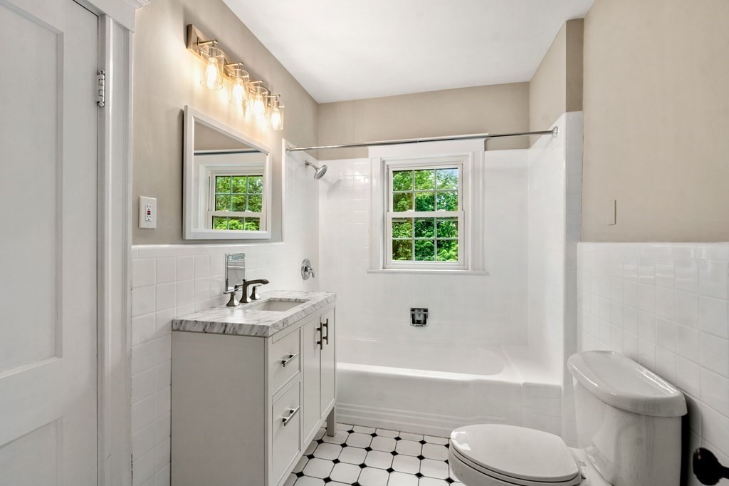 95 Russett Road Boston, MA 02132 - Photo 20 of 42 a bathroom with a bathtub toilet sink vanity and windows