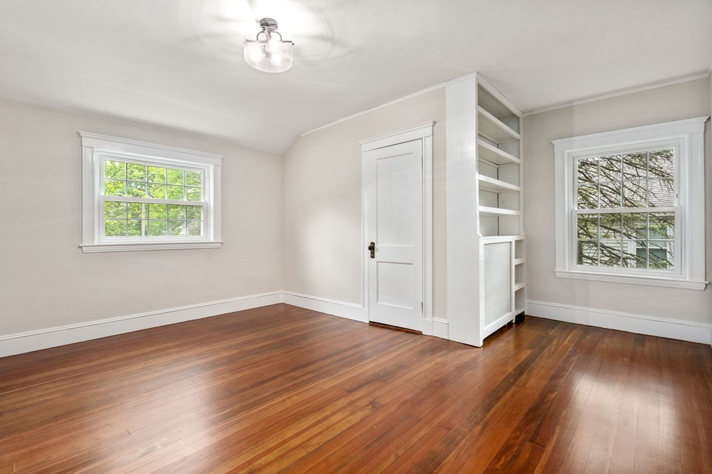 95 Russett Road Boston, MA 02132 - Photo 24 of 42 a view of an empty room with wooden floor and a window
