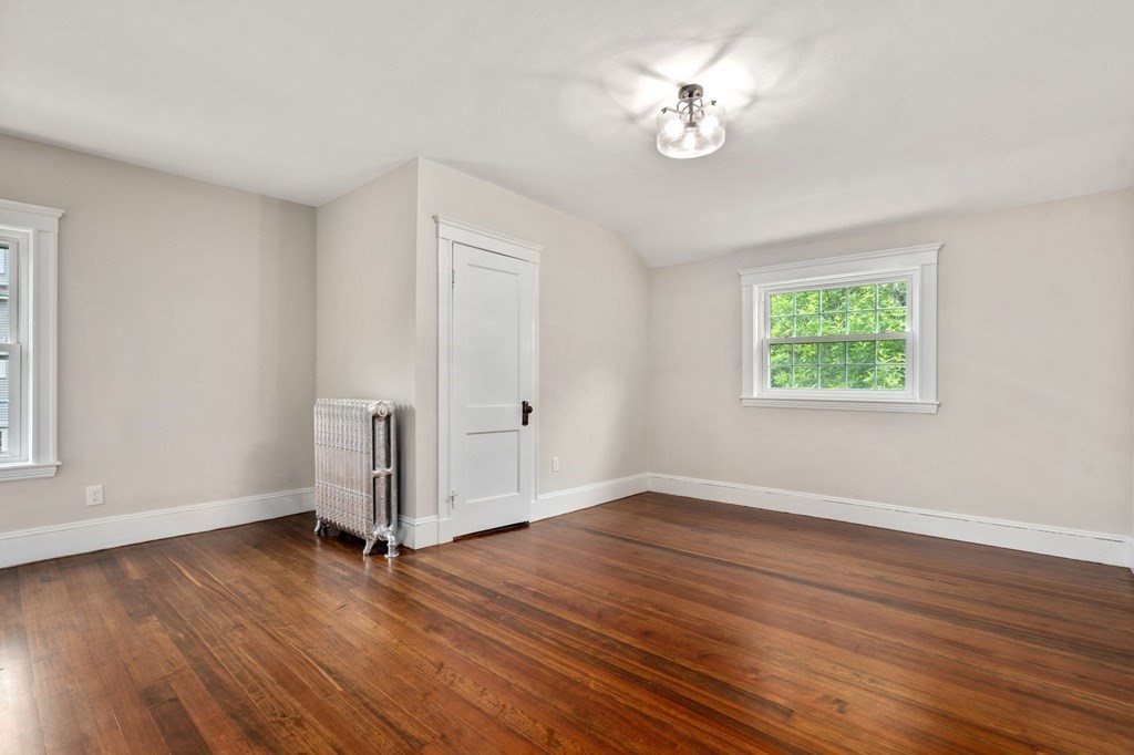 95 Russett Road Boston, MA 02132 - Photo 25 of 42 a view of a room with wooden floor and a ceiling fan