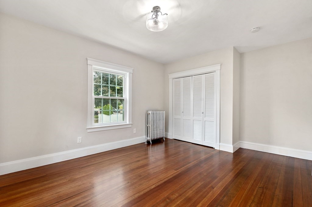 95 Russett Road Boston, MA 02132 - Photo 28 of 42 a view of empty room with wooden floor and fan