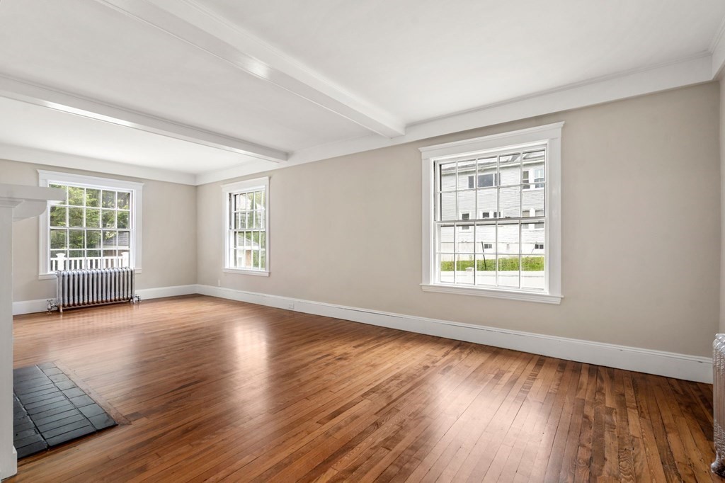 95 Russett Road Boston, MA 02132 - Photo 29 of 42 an empty room with wooden floor and windows