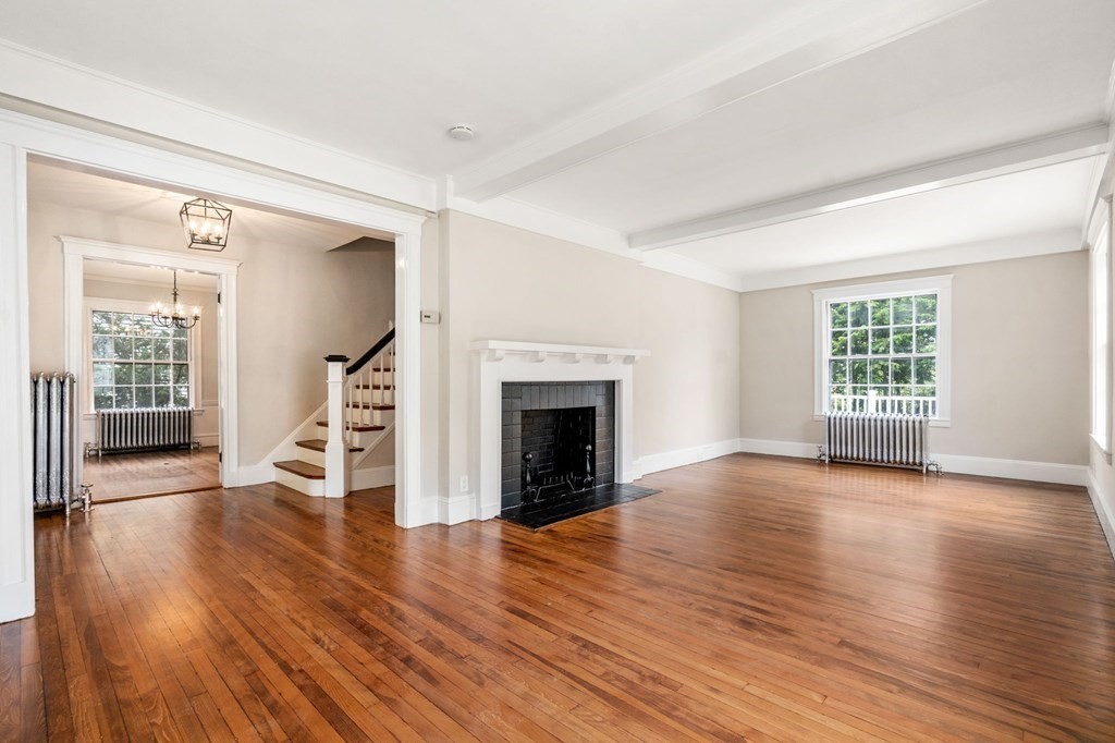 95 Russett Road Boston, MA 02132 - Photo 30 of 42 an empty room with wooden floor fireplace and windows