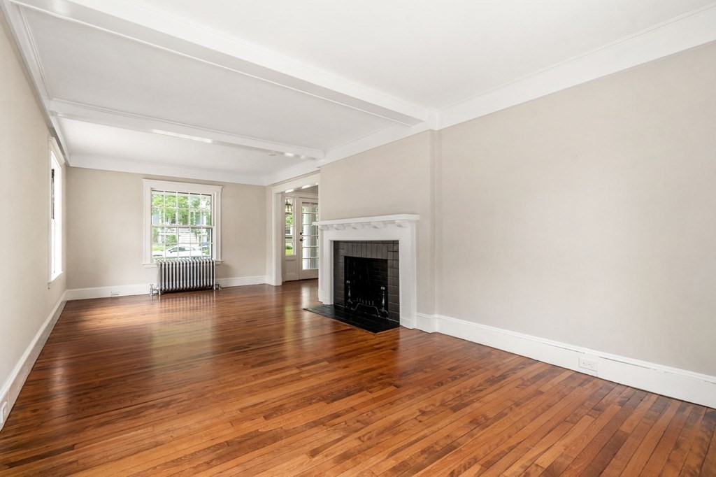 95 Russett Road Boston, MA 02132 - Photo 31 of 42 wooden floor fireplace and windows in an empty room