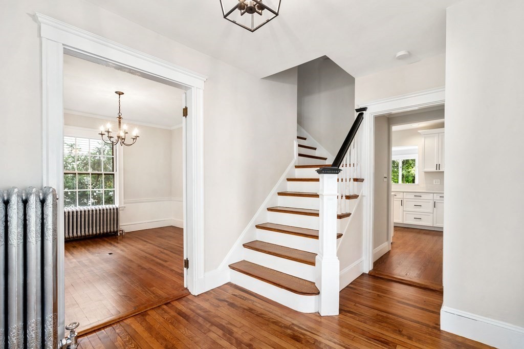 95 Russett Road Boston, MA 02132 - Photo 9 of 42 a view of entryway with wooden floor and stairs