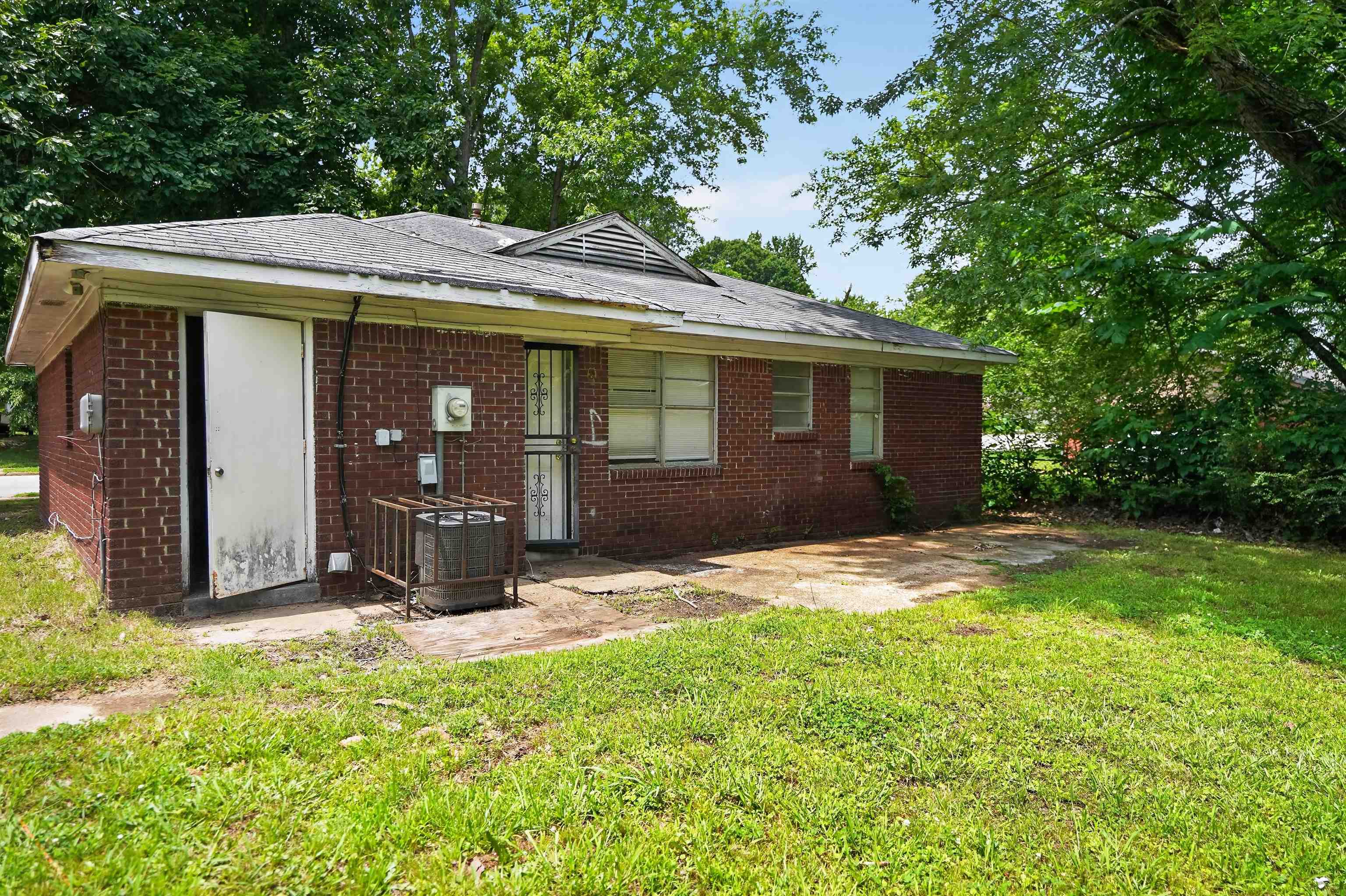 4530 Spring Valley Drive Memphis, TN 38128 - Photo 3 of 15 Brick exterior with a partial concrete patio and expansive green space