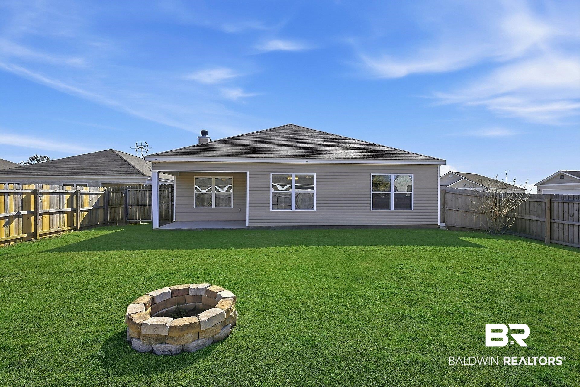983 Summerton Drive Foley, AL 36535 - Photo 2 of 25 Rear view of property featuring a patio area, a fire pit, a fenced backyard, and a shingled roof