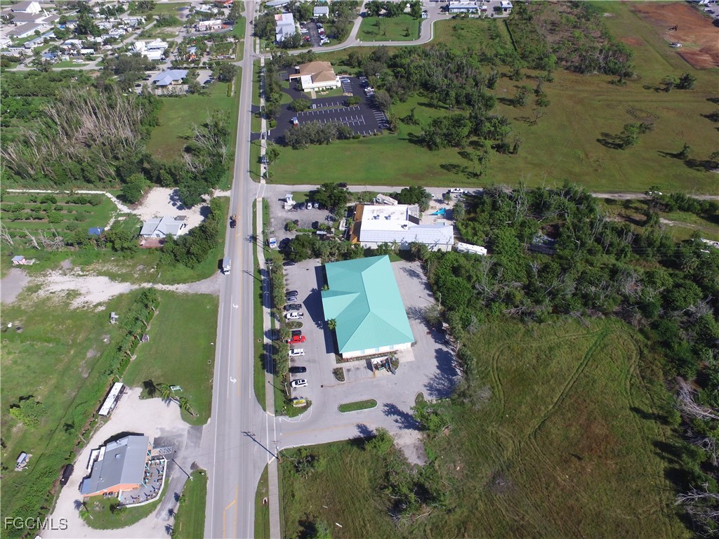 10250 Stringfellow Road St. James City, FL 33956 - Photo 4 of 8 an aerial view of a house with a yard and lake view