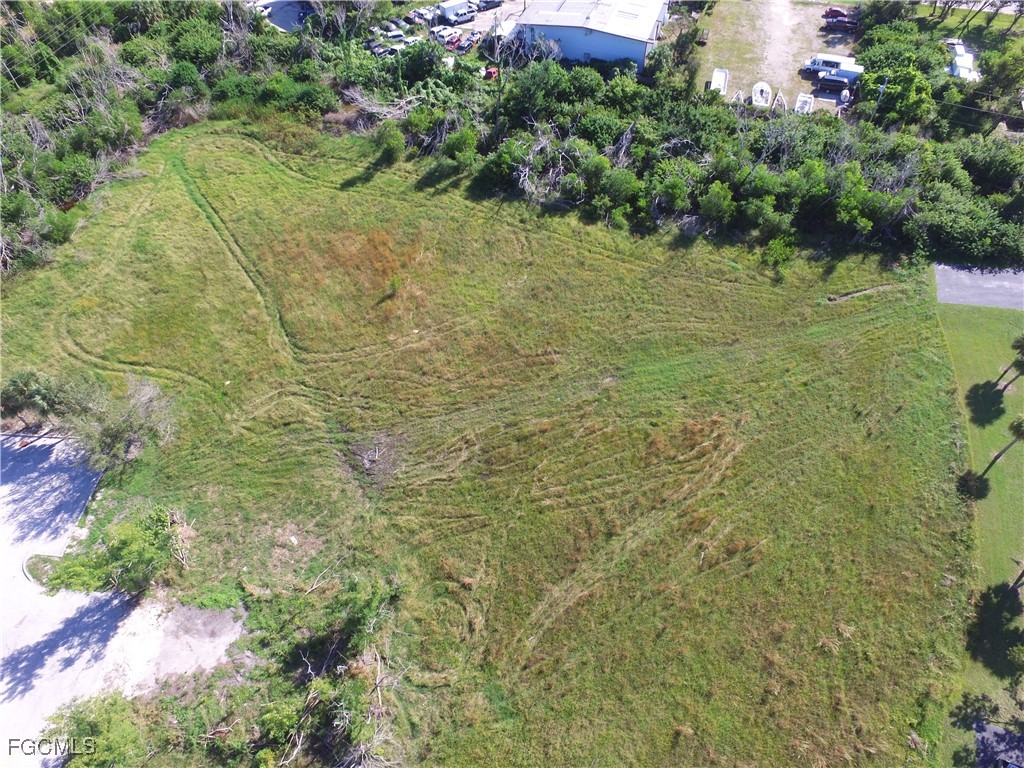 10250 Stringfellow Road St. James City, FL 33956 - Photo 7 of 8 a bathroom with a small yard and green space