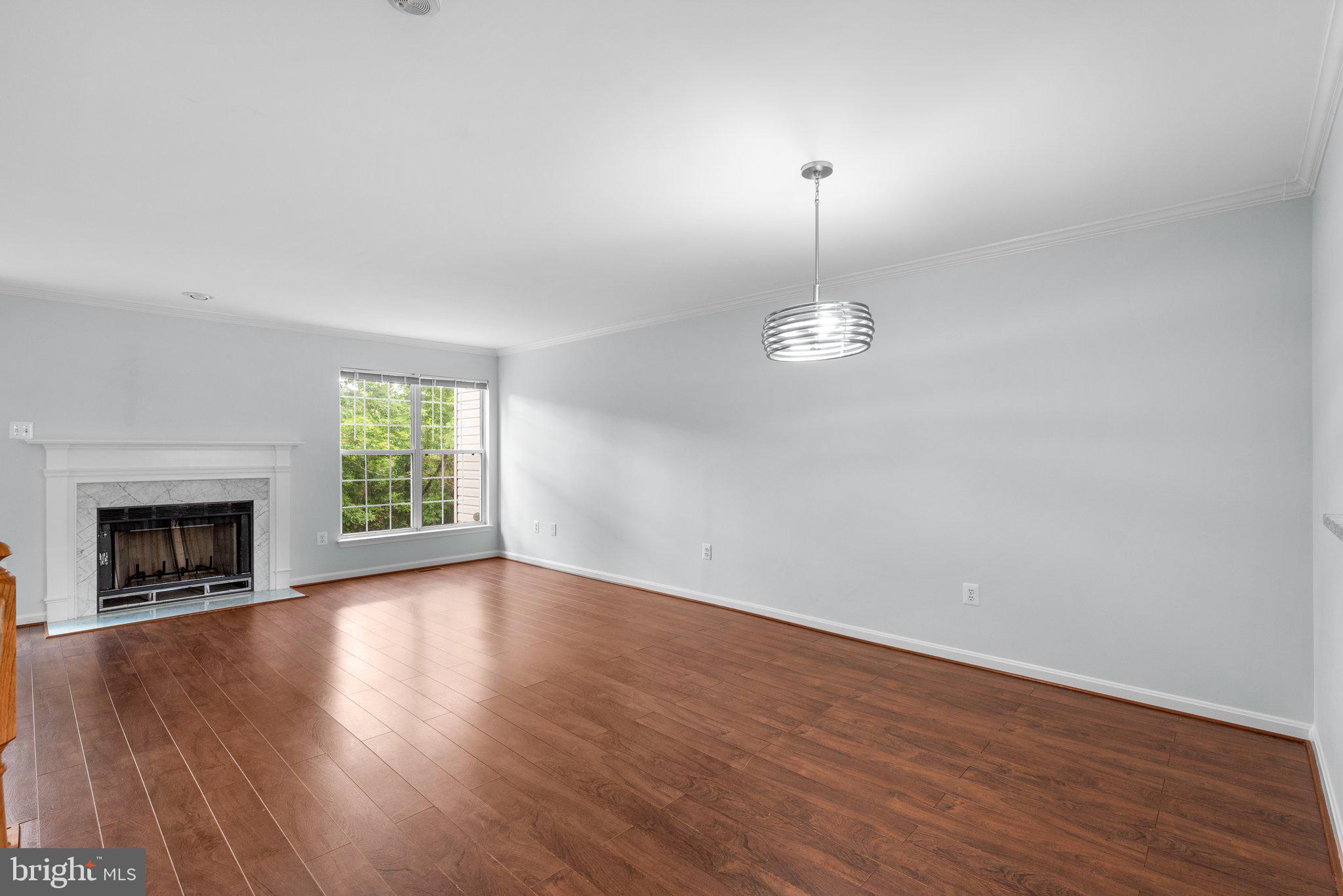 2204 Commissary Circle Odenton, MD 21113 - Photo 13 of 49 an empty room with wooden floor fireplace and window