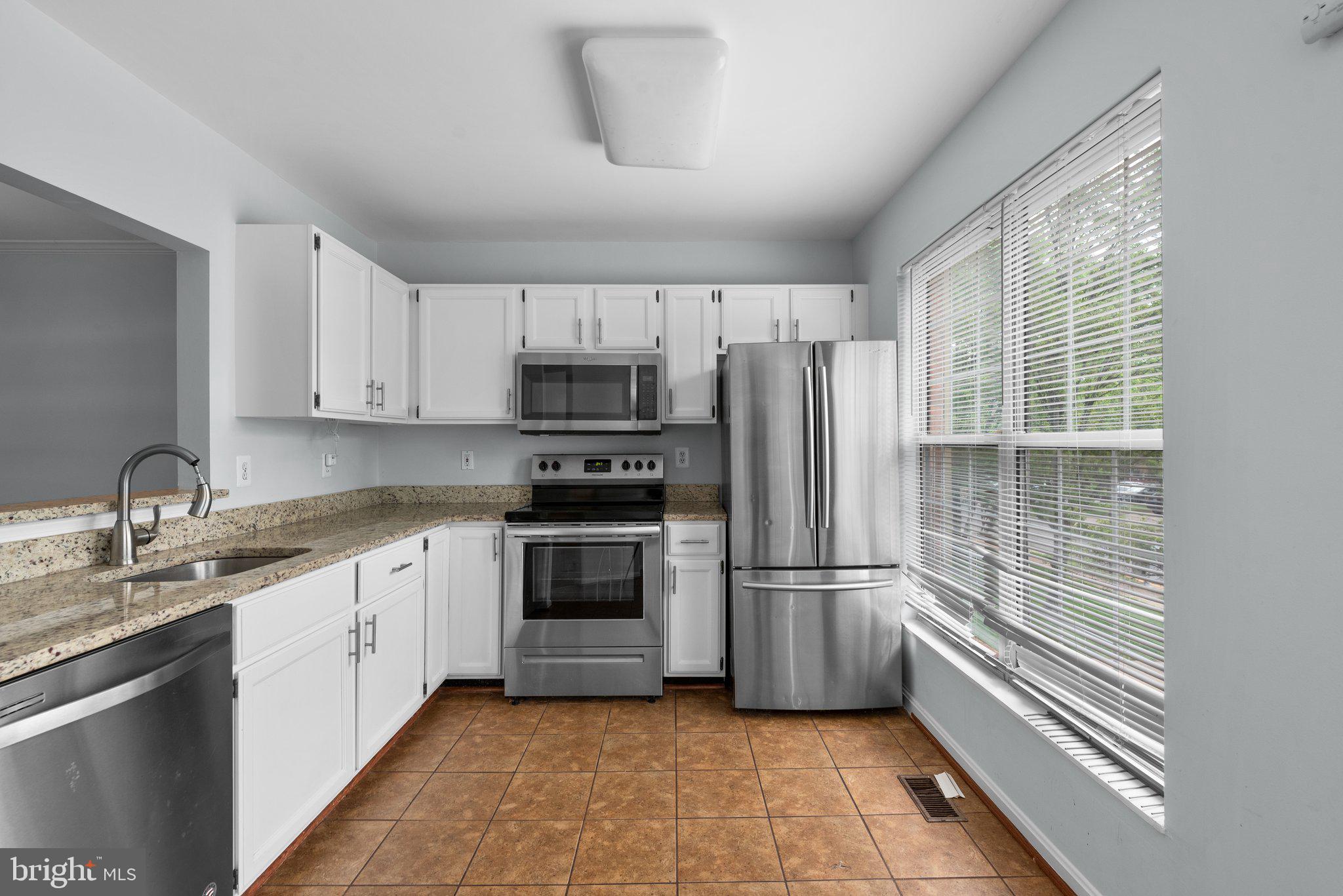 2204 Commissary Circle Odenton, MD 21113 - Photo 15 of 49 a kitchen with stainless steel appliances a refrigerator sink and microwave