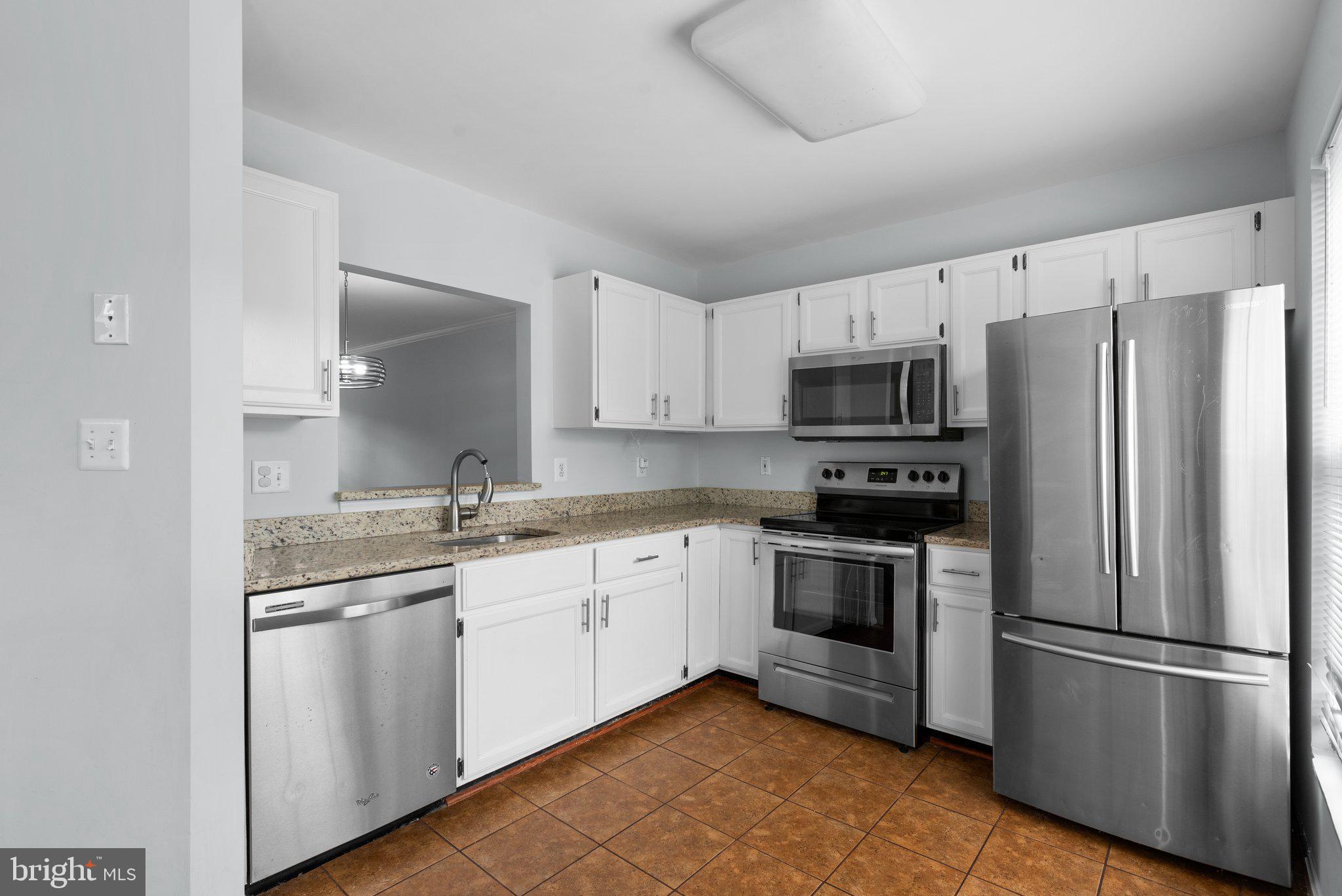 2204 Commissary Circle Odenton, MD 21113 - Photo 16 of 49 a kitchen with stainless steel appliances a refrigerator sink and microwave