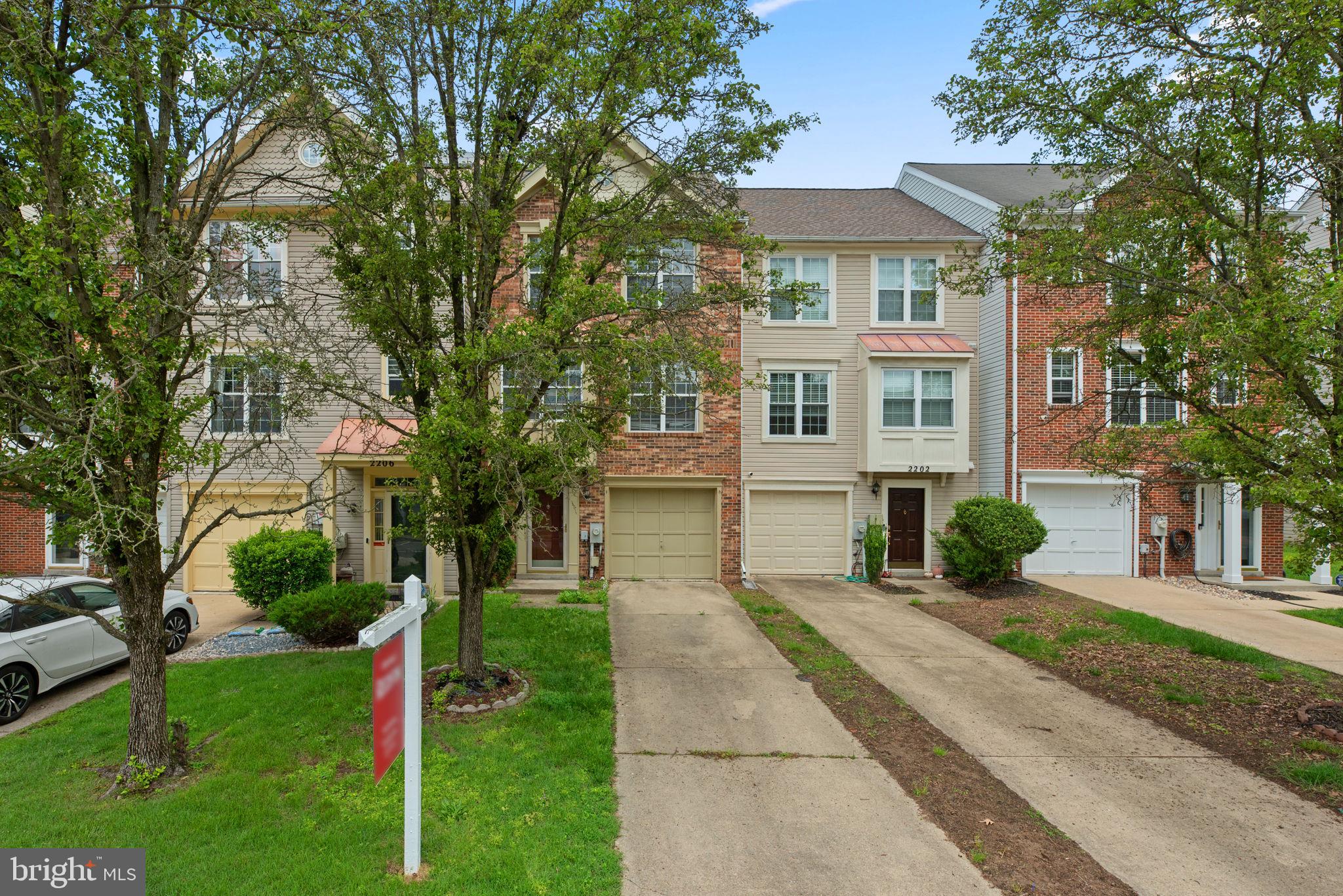 2204 Commissary Circle Odenton, MD 21113 - Photo 2 of 49 a front view of a house with a yard and trees