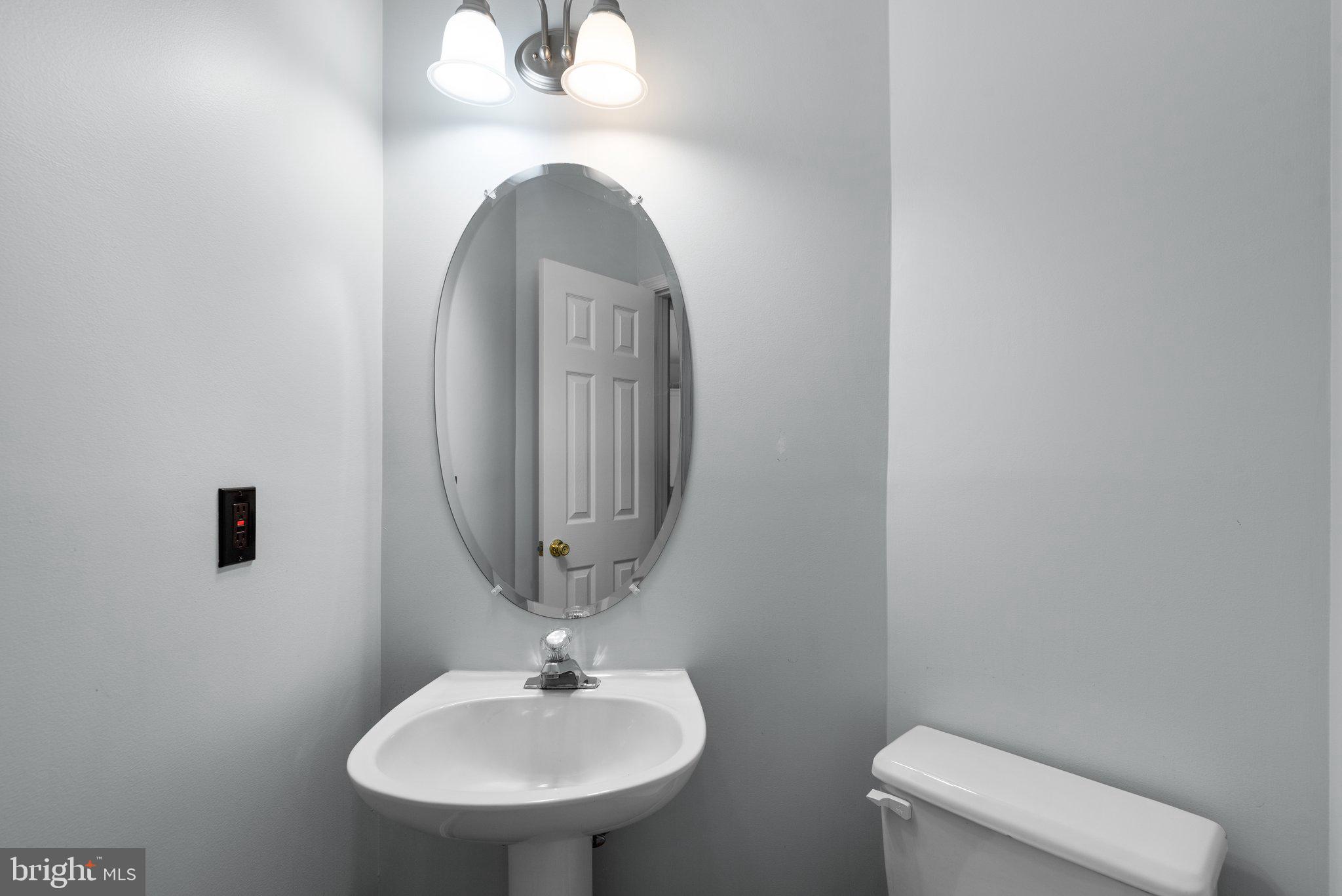 2204 Commissary Circle Odenton, MD 21113 - Photo 21 of 49 a bathroom with a toilet sink and mirror