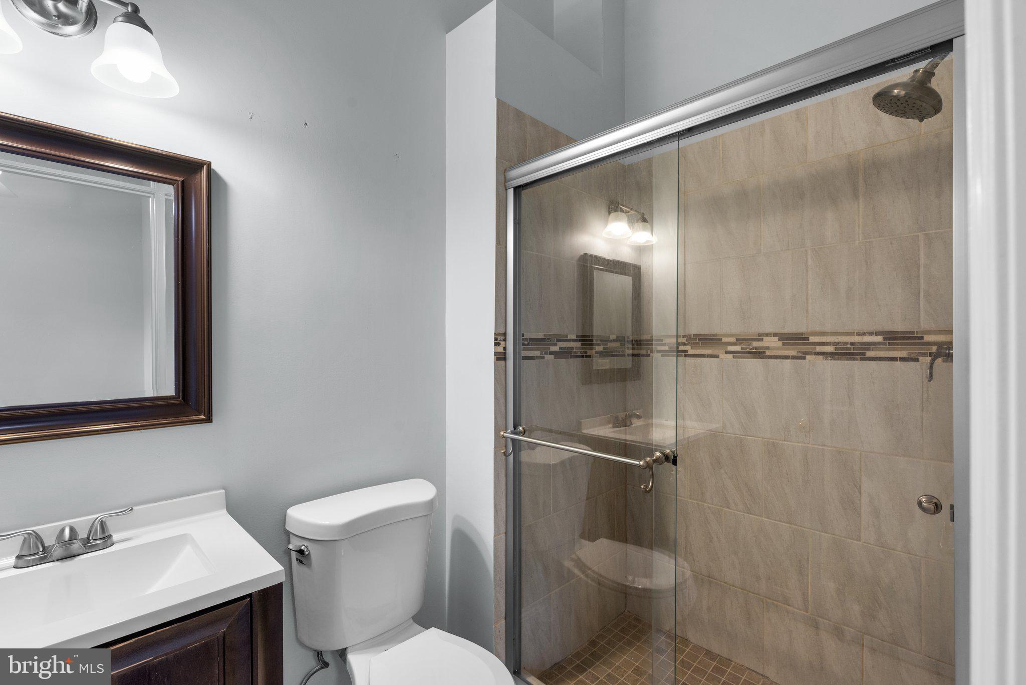 2204 Commissary Circle Odenton, MD 21113 - Photo 28 of 49 a bathroom with a toilet sink and shower