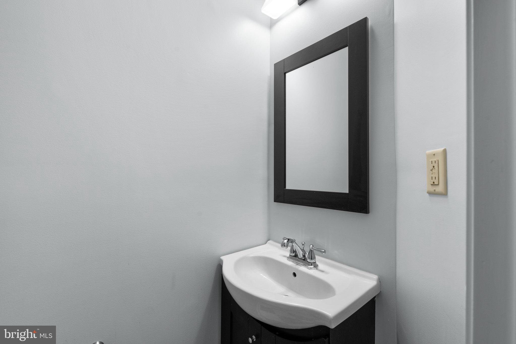 2204 Commissary Circle Odenton, MD 21113 - Photo 42 of 49 a bathroom with a sink and a mirror