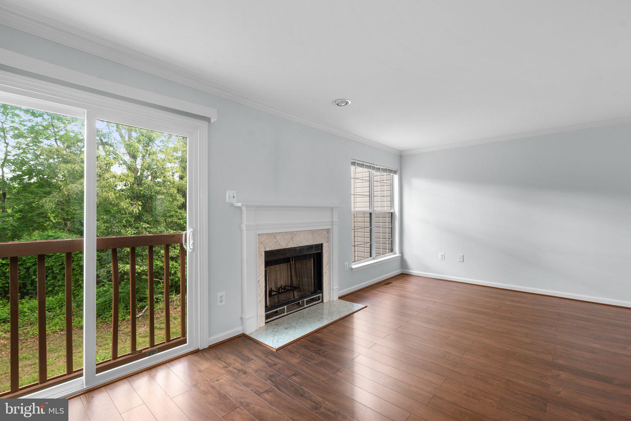 2204 Commissary Circle Odenton, MD 21113 - Photo 8 of 49 a view of an empty room with wooden floor and a window